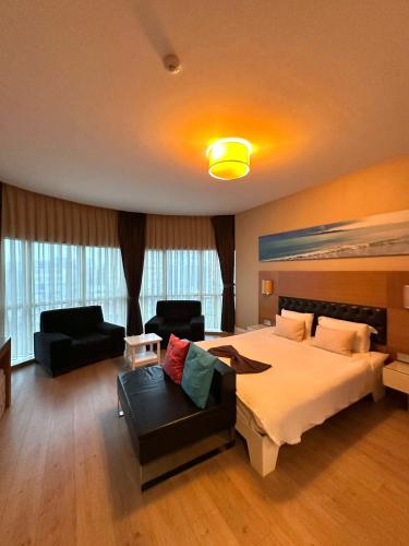 a hotel room with a large bed and a couch at City Hotel Plovdiv FREE PARKING in Plovdiv