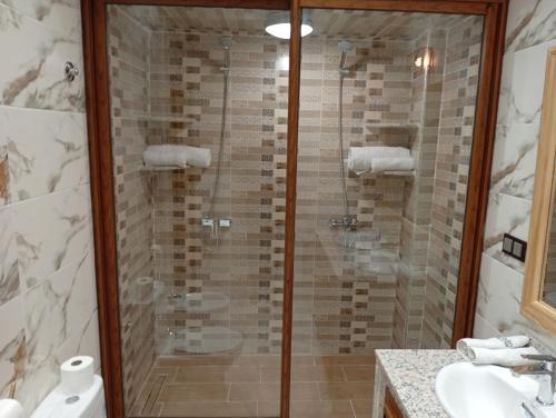 a bathroom with a shower and a toilet and a sink at Dar AWRABIA in Fez
