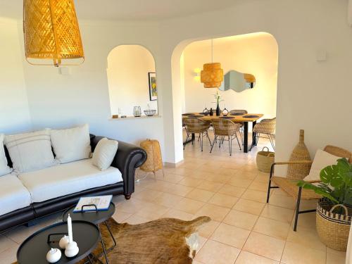 a living room with a couch and a table at Villa Flores in Carvoeiro