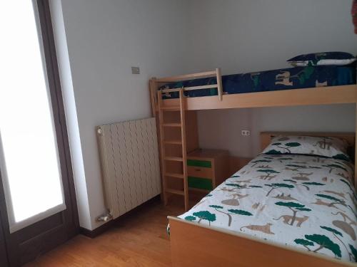 a bedroom with two bunk beds and a ladder at Villetta Eden Schilpario in Schilpario