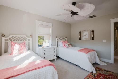 a bedroom with two beds and a ceiling fan at Coastal Quarters Condo in Bluffton