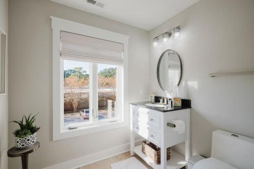 a bathroom with a sink and a mirror at Coastal Quarters Condo in Bluffton