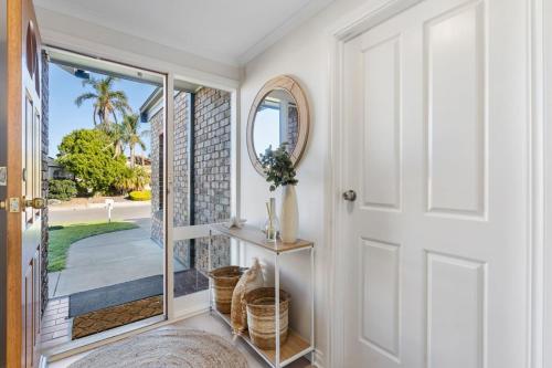 a hallway with a door leading to a patio at The Water House - Lakeside Serenity & Modern Comfort in Encounter Bay