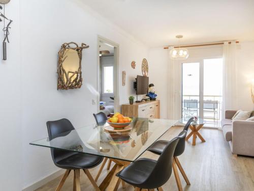 a dining room with a glass table and chairs at Apartment Platja Mar by Interhome in L'Escala
