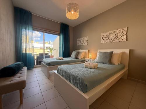 a bedroom with two beds and a window at John Shelter in Portimão