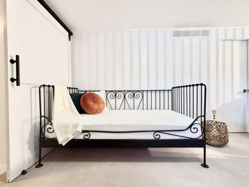 a black bed with a pillow on it in a room at Montreal - Laval Haven - Entire Rental Unit in Laval