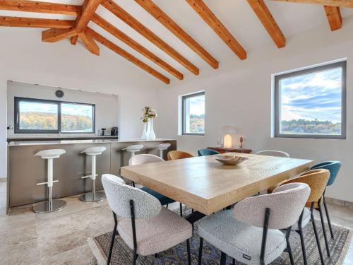 a dining room with a wooden table and chairs at Villa Maison Paradis by Interhome in Višnjan