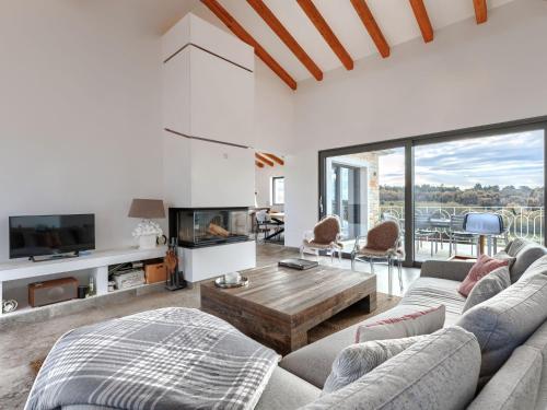 a living room with a couch and a table at Villa Maison Paradis by Interhome in Višnjan