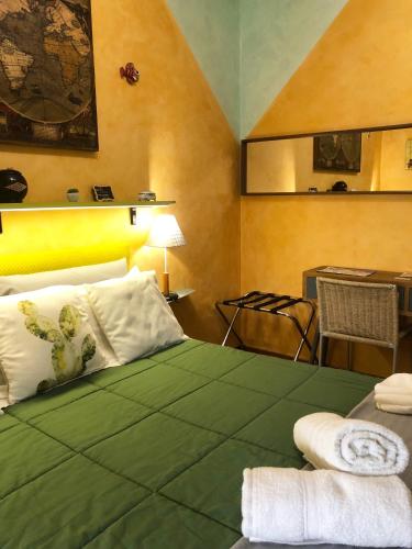 a bedroom with a large green bed with a desk and a desk at Rizzi Marianna B&B in Monopoli