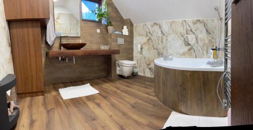 a bathroom with a large tub and a sink at Apartmánový Dom Terchová in Terchová