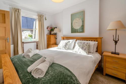 a bedroom with a large bed with towels on it at 1 Bed in Errol oc-s33022 in Errol