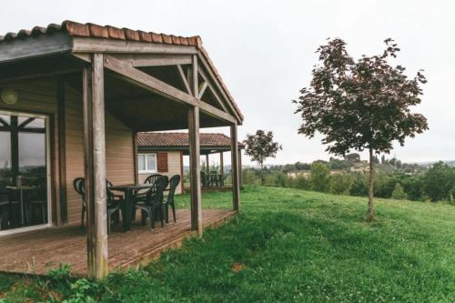 a gazebo with a table and chairs in a field at ZEcamping 3 étoiles dog friendly avec piscine couverte et chauffée in Monclar-de-Quercy