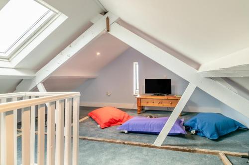 a attic room with two beds and a television at 3 Bed in Minehead oc-r30941 in Minehead