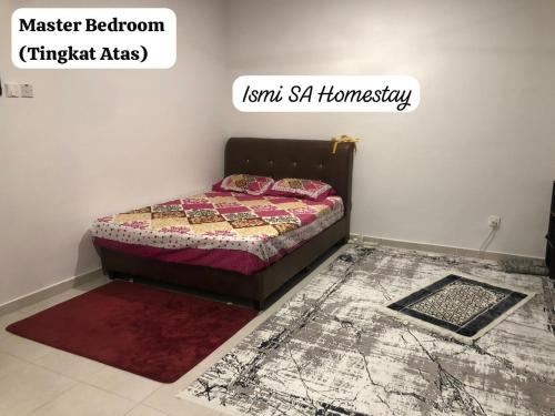a bedroom with a bed with a rug on the floor at Ismi SA Homestay in Rawang