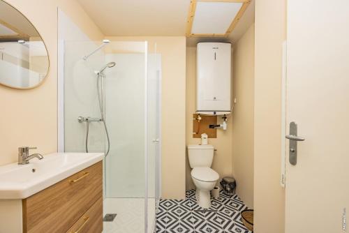 a bathroom with a toilet and a sink and a shower at Le Figuier - Studio de Charme in Lavaur