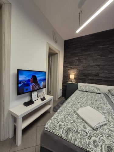 a bedroom with a bed and a flat screen tv at Studio Apartman 47B in Valjevo