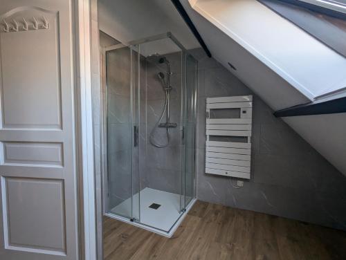 a bathroom with a shower in a attic at La fermette du Marais in Rue