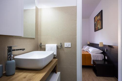 a bathroom with a sink and a bed at I Tigli in Valmontone