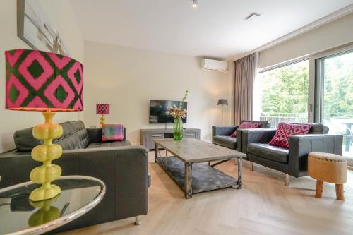 a living room with a couch and a table at Park Central Executive 102 in The Hague