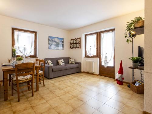 a living room with a couch and a table at Apartment The Silent Sylva by Interhome in Isolaccia