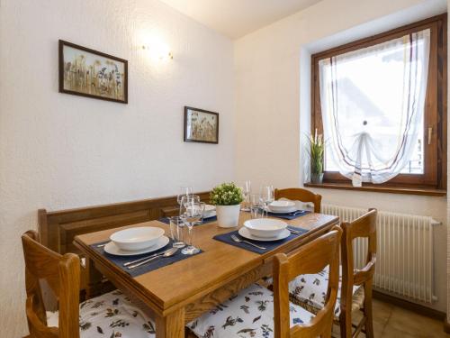 a dining room with a wooden table and chairs at Apartment The Silent Sylva by Interhome in Isolaccia