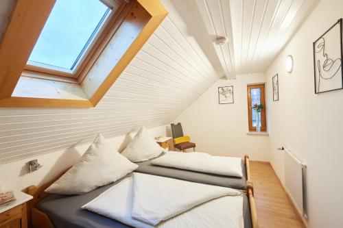 a room with two beds and a window at Gästehaus Höfler in Bayerisch Gmain