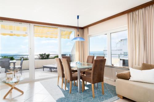 a living room with a table and chairs and a couch at Miramar Whg 513 in Grömitz