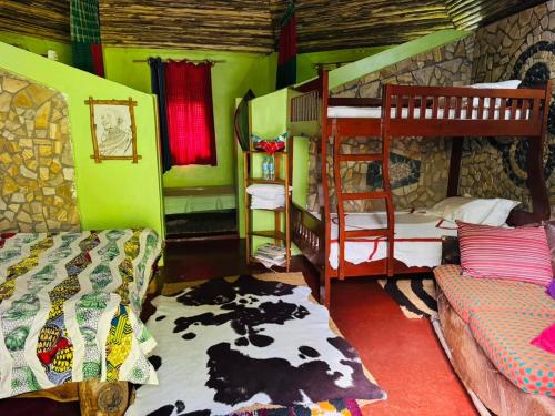 a room with two bunk beds and a couch at Oldadai Falls Retreat in Arusha