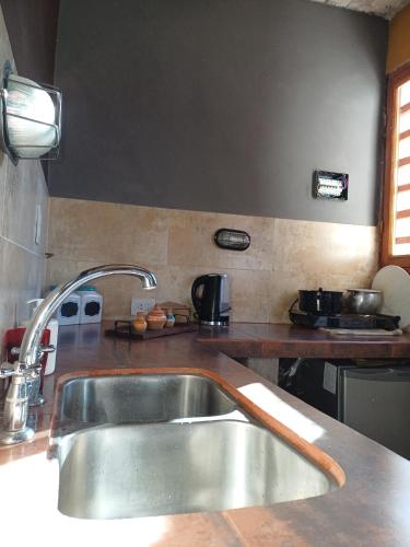 a kitchen with a sink and a counter top at Cabaña Aklla in Tilcara