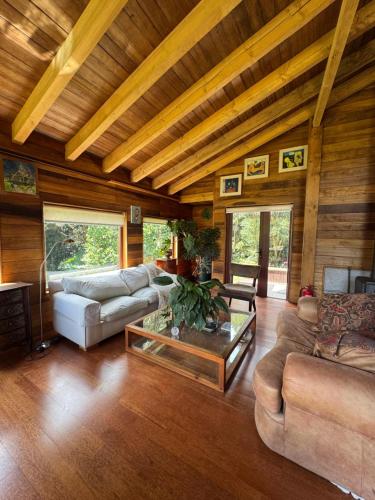 a living room with couches and a coffee table at Casa Arrayan in Puerto Varas