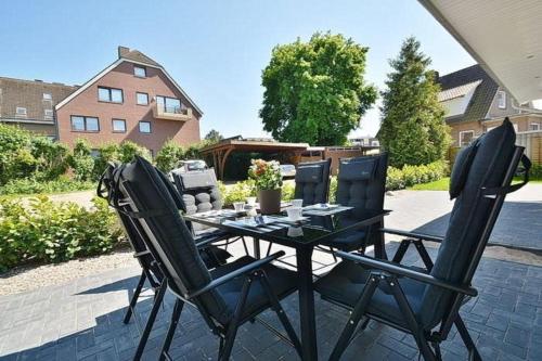 a table and two chairs on a patio at Haus Fischerstraße 6a in Grömitz