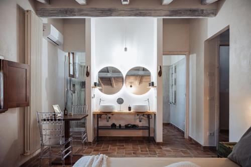 a room with two mirrors on the wall and a sink at Casale Tasciotto in Genazzano