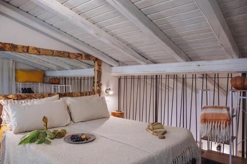 a bedroom with a bed with a plate of fruit on it at Casale Tasciotto in Genazzano