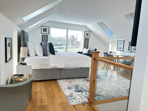 a bedroom with a large bed and a table at The Wold - Air-Conditionned Studio Burton Latimer in Burton Latimer