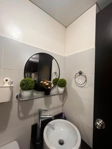 a bathroom with a sink and a mirror at Kasara Resort Condotel by Vhi in Manila