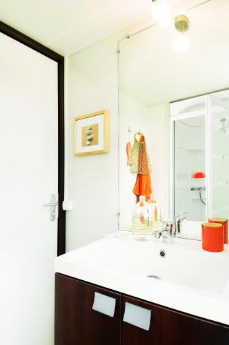 a bathroom with a sink and a mirror at Charmant camping Familiale 3 Etoiles vue 360 plage piscine à débordement empl XXL in Labeaume