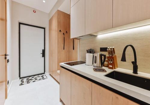 a kitchen with a sink and a counter top at Modern Spaces U-Tower in Tashkent