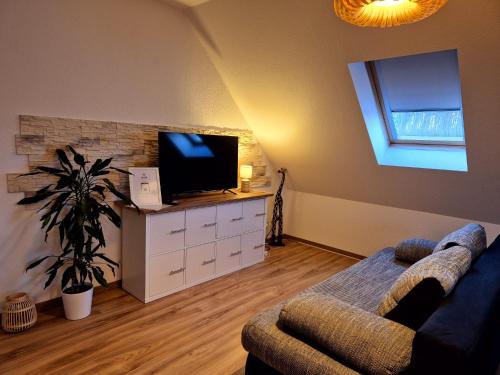 a living room with a couch and a flat screen tv at Ferienwohnung Sunny 2 in Mittenwalde
