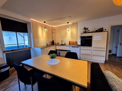 a kitchen with a table and a dining room at Ferienwohnung Sunny 2 in Mittenwalde