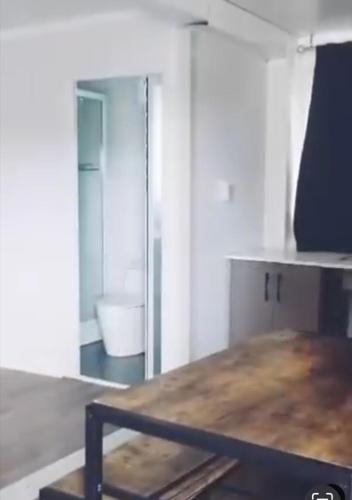 a room with a wooden table and a mirror at Villa Gregorio mountain top in Bonao