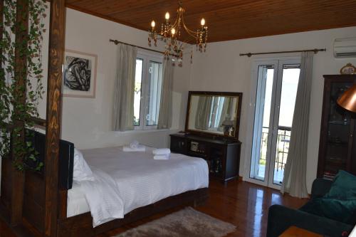 a bedroom with a bed and a mirror and a couch at Holiday Cottage in Lílaia
