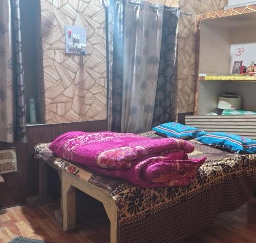 a purple blanket sitting on top of a bench at Siddhi's Inn in Prayagraj