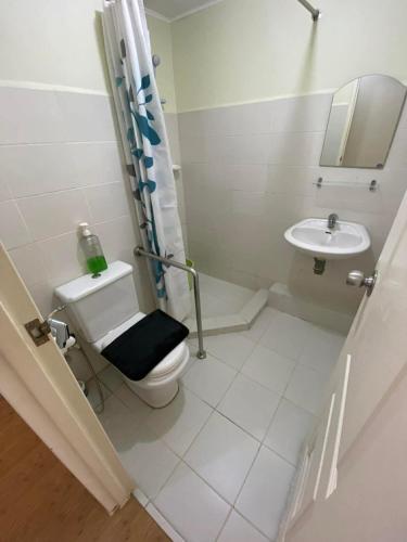 a bathroom with a toilet and a sink at Chic Studio near Ocean Park in Cebu City