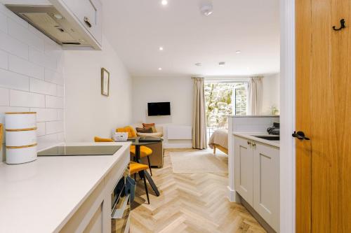 a kitchen with a counter and a living room at Rock Mill - Deluxe Apartments with Private Terrace in Stony Middleton