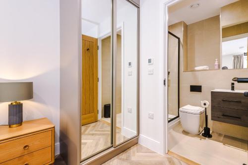 a bathroom with a shower and a toilet and a sink at Rock Mill - Deluxe Apartments with Private Terrace in Stony Middleton