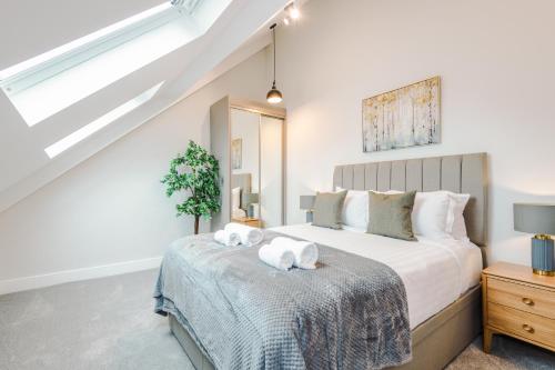 a bedroom with a bed with two white towels on it at No.44 - Deluxe 2-Bedroom Duplex with Balcony in Stony Middleton