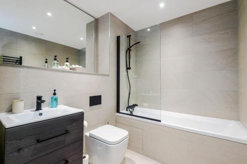 a bathroom with a toilet and a sink and a shower at Rock Mill - 2-Bedroom Duplex Apartments in Stony Middleton