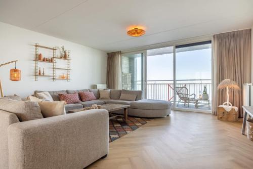 a living room with a couch and a table at Hello Zeeland - Port Scaldis 11-031 in Breskens