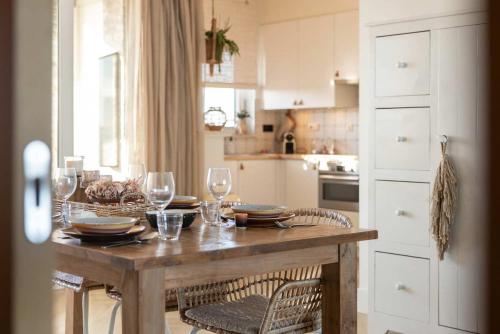 a kitchen with a table with wine glasses on it at Hello Zeeland - Port Scaldis 11-031 in Breskens