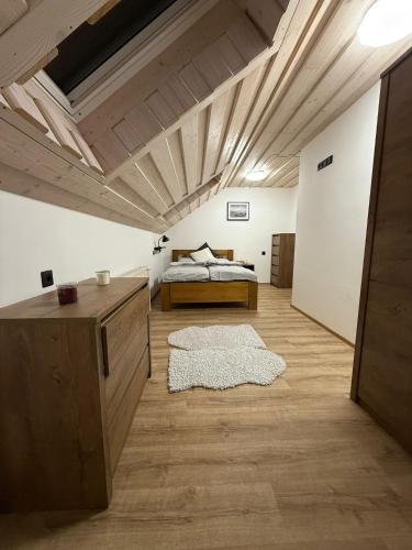 a bedroom with a bed and a wooden ceiling at Apartmany Zvole in Zvole